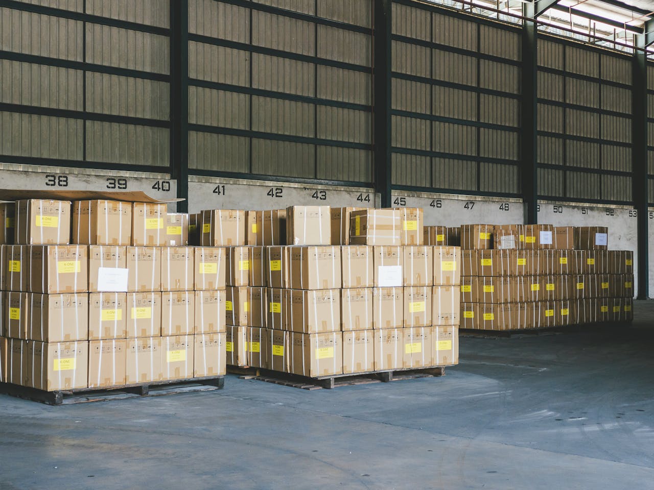 brand-01 Cardboard boxes stacked on pallets in an organized warehouse in Ipoh, Malaysia.