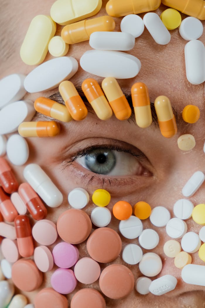 creative-02 Artistic close-up of a human eye adorned with assorted colorful pills, highlighting modern healthcare themes.