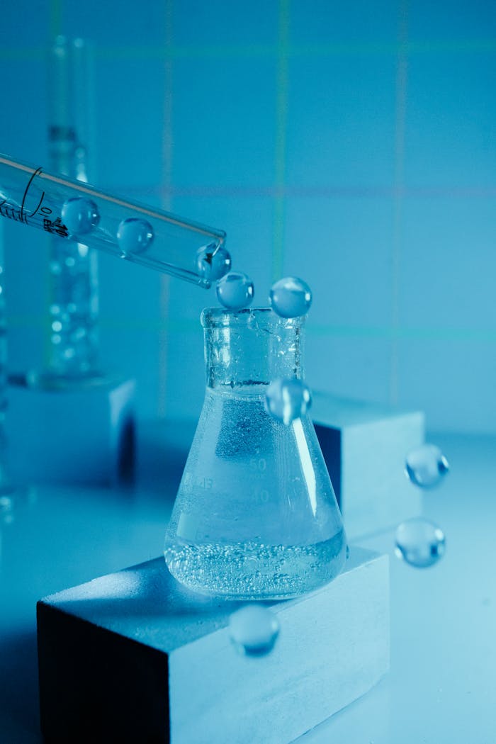creative-01 Laboratory experiment showcasing a beaker with bubbling liquid and pipette against a blue backdrop.